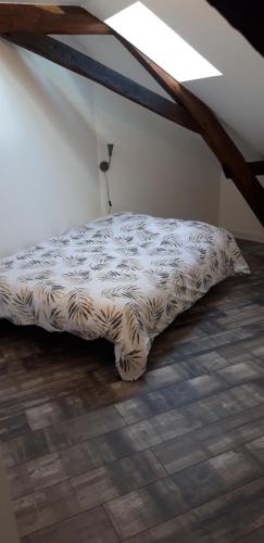 a bed sitting on the floor in a room at À 18min du ZOO 30min des 24h du Mans in Le Lude