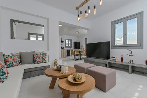 a living room with a couch and a tv at Villa Tranquillity in Kastraki