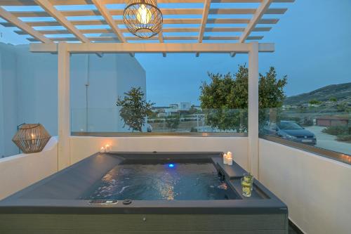 a hot tub on a balcony with a view at Villa Tranquillity in Kastraki Naxou
