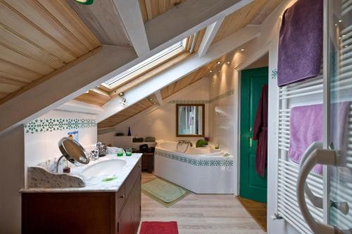 a bathroom with a tub and a sink and a bath room at Villa de Jade in Le Palais