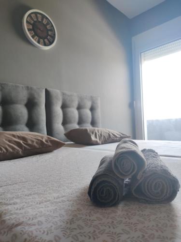 a bedroom with a bed with a clock on the wall at House of Sunset - Tranquility - View - Relaxation in Sívas