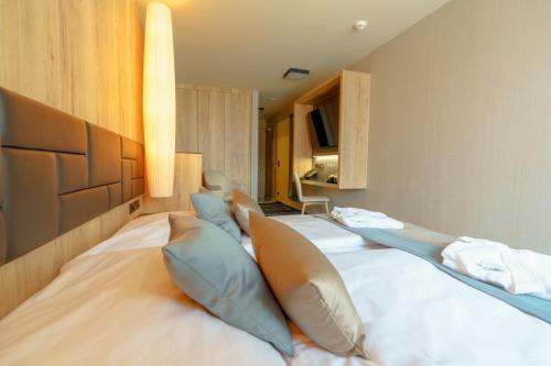a bedroom with two beds with pillows on it at Hotel Hills in Tatranská Lomnica