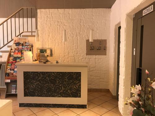 a store with a fireplace in the middle of a room at Hotel Alpes Cevennes in Guilherand