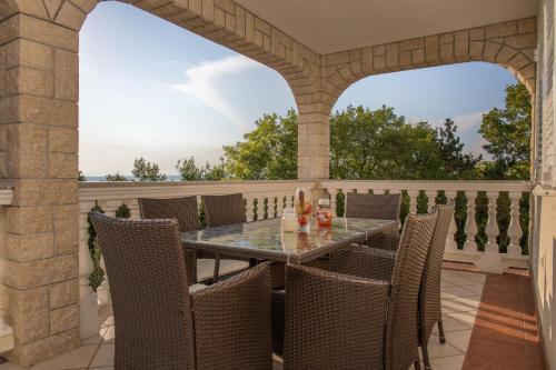 an outdoor patio with a table and chairs at Apartments RUZA in Crikvenica