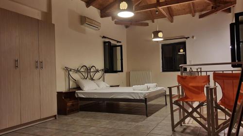 a bedroom with a bed and a chair in it at Frigano 1 in Stoupa