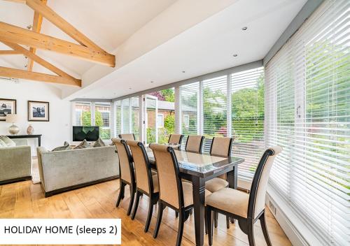a dining room with a table and chairs at Cadnam Lodge in Cadnam