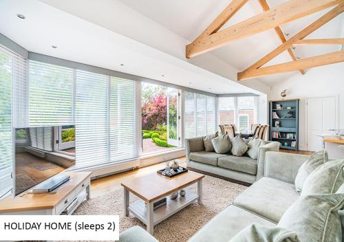 a living room with a couch and a table at Cadnam Lodge in Cadnam