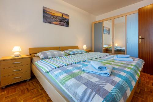 a bedroom with a bed with towels on it at Apartment Ruzica in Crikvenica