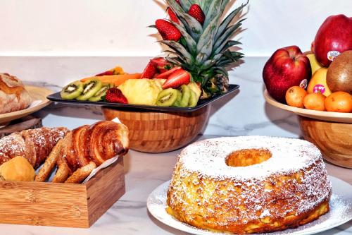 a table topped with different types of bread and fruit at Vele d'Otranto B&B in Otranto