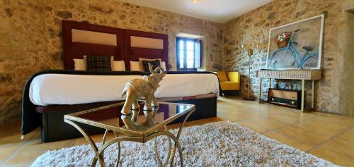 a bedroom with a bed and a statue of a deer on a table at Ecocasa Lema II in Muxia