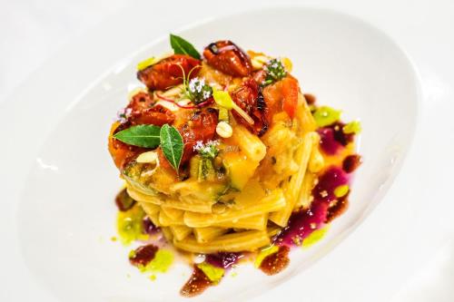 a plate of food with pasta on a white plate at Hotel Rosalba - Valentini Family Village in Bellaria-Igea Marina