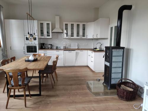 a kitchen with a wooden table and a stove at Schulhaus Wettges in Birstein