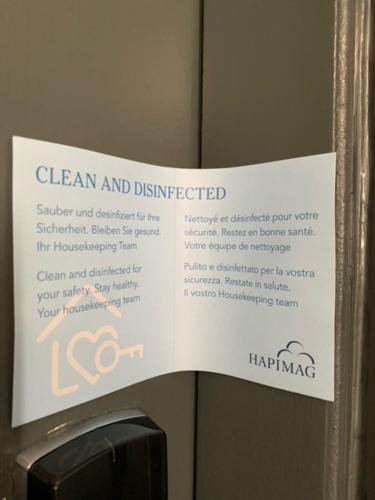 a sign that says clean and disinfected on a refrigerator at Hapimag Apartments London in London