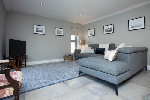 a living room with a couch and a tv at Kilbroney River Cottage in Rostrevor