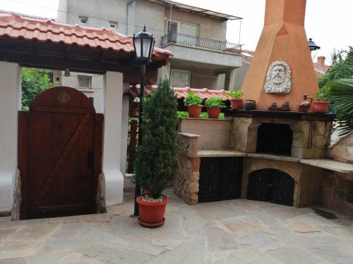 a house with a courtyard with a fireplace and a door at Moreno in Sozopol