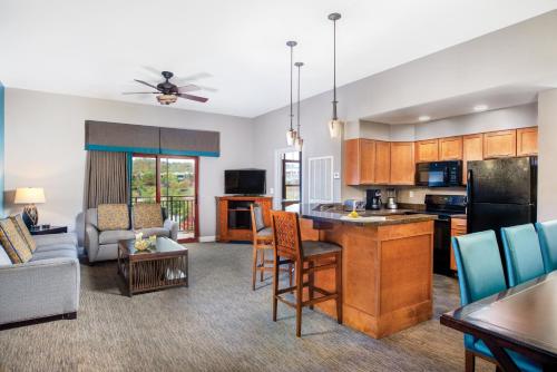 a kitchen and living room with a couch and a table at Club Wyndham Great Smokies Lodge in Sevierville