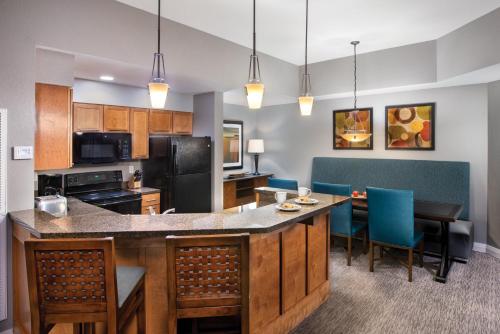 a kitchen with a table, chairs and a microwave at Club Wyndham Great Smokies Lodge in Sevierville