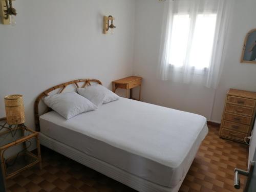 a bedroom with a white bed with a window at Marina Port Camargue in Le Grau-du-Roi