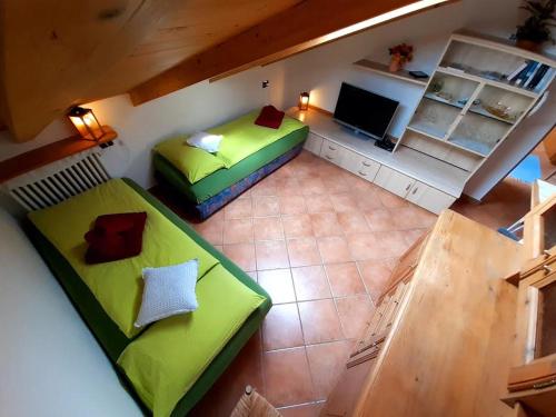 an overhead view of a room with two green beds at 9598 SS301 Trepalle APPARTAMENTO MIKI in Livigno