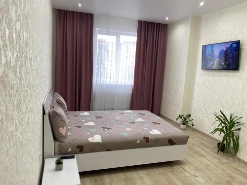 a bedroom with a bed with hearts on it at 2 кімнатні ,Люкс апартаменти в ЖК Арена ,район автовокзалу in Rivne