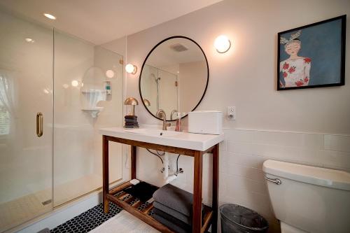 a bathroom with a sink and a mirror and a toilet at Artsy Hidden Gem - FREE PARKING in Philadelphia