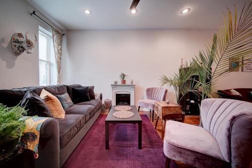 a living room with a couch and a table at Artsy Hidden Gem - FREE PARKING in Philadelphia