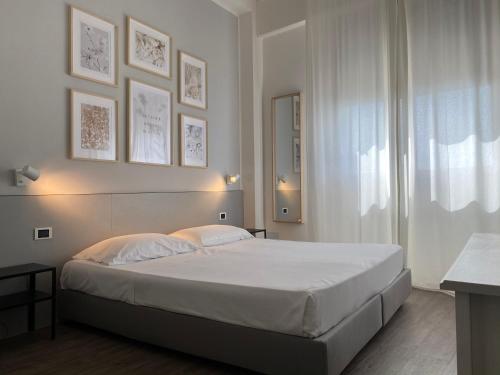 a bedroom with a large white bed and a window at Il Romito in Quercianella