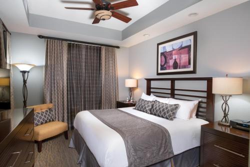 a bedroom with a bed and a ceiling fan at Club Wyndham Great Smokies Lodge in Sevierville