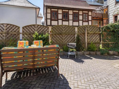 a wooden bench sitting in front of a fence at Stylish apartment with terrace in Sonneberg in Sonneberg