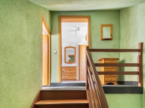 a staircase in a room with green walls at Stylish apartment with terrace in Sonneberg in Sonneberg