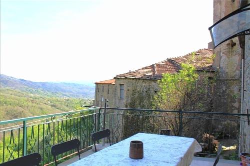 a table and chairs on a balcony with a view at IL NIDO VERDE in Groppo