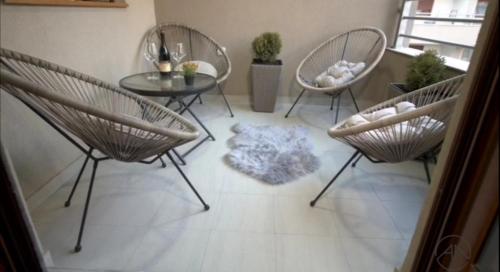 a living room with three chairs and a table at NOVAK apartman in Vrnjačka Banja