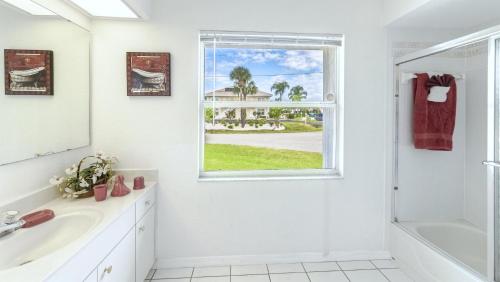 a bathroom with a sink and a window at !NEW! Villa Rosa & Lucia in Cape Coral