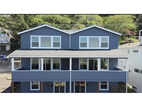a blue house with a roof at The Captains Lookout Sleeps 6, Hot Tub, Pet Friendly, Ocean View in Depoe Bay