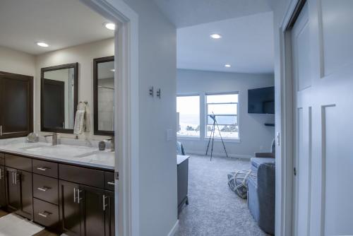 a bathroom with a sink and a mirror at Oceanview Townhome - Pet Friendly - Sleeps 6 - King in Depoe Bay