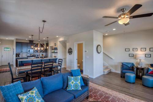 a living room and dining room with a blue couch at The Captains Lookout Sleeps 6, Hot Tub, Pet Friendly, Ocean View in Depoe Bay