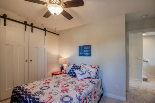 a bedroom with a bed and a ceiling fan at The Captains Lookout Sleeps 6, Hot Tub, Pet Friendly, Ocean View in Depoe Bay