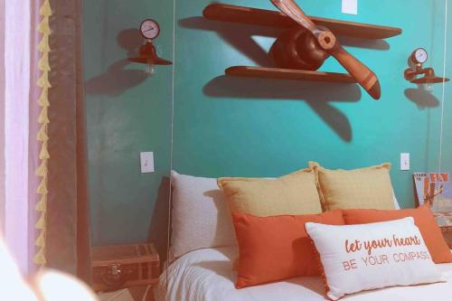 a bedroom with a bed with a fan on the wall at Sol-O-Cien Estrella in Rosarito