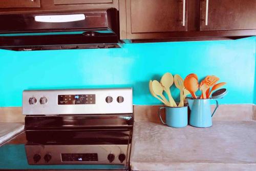 a kitchen counter with two containers of kitchen utensils at Sol-O-Cien Estrella No Check Out Chores in Rosarito