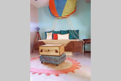 a room with a bed with a parachute hanging from the ceiling at Sol-O-Cien Estrella No Check Out Chores in Rosarito