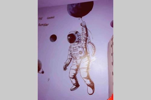 a drawing of an astronaut holding a balloon at Sol-O-Cien Estrella No Check Out Chores in Rosarito