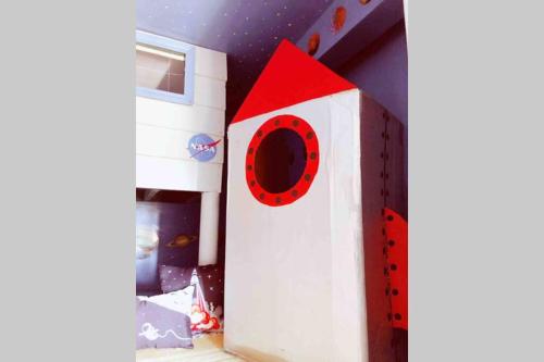 a toy house with a red roof in a room at Sol-O-Cien Estrella No Check Out Chores in Rosarito