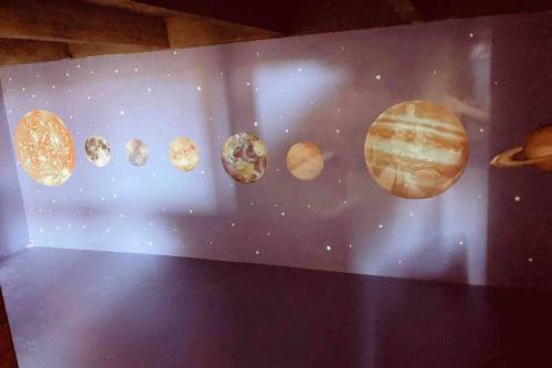 a wall with the planets of the solar system at Sol-O-Cien Estrella No Check Out Chores in Rosarito