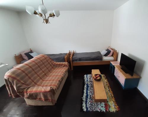 a living room with a couch and a table at Babičkin Dom in Medzilaborce
