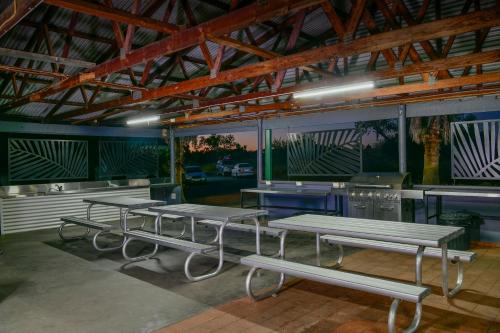 a group of picnic tables in a building at Desert Palms Alice Springs in Alice Springs