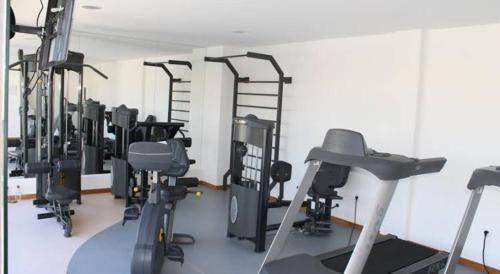 a gym with rows of exercise equipment in a room at SOLARIS IMBASSAÍ in Imbassai