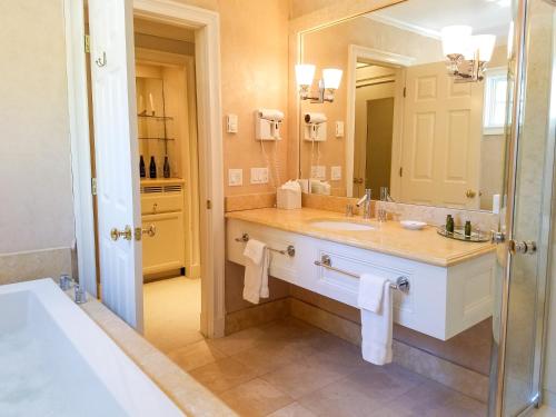 a bathroom with a sink and a large mirror at Copper Beech Inn in Ivoryton