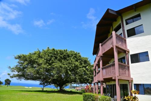 a building with a tree next to it at Club Wyndham Ka Eo Kai in Princeville