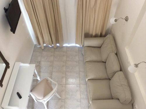 a living room with a couch and a chair at Filoxenia Beach Hotel in Rethymno Town