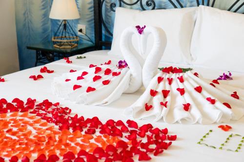 two swans dressed up as hearts on a bed at Azura Gold Hotel & Apartment in Nha Trang